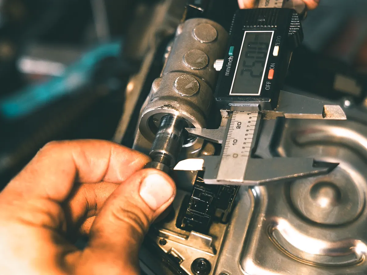 Measuring a machined part with a digital caliper