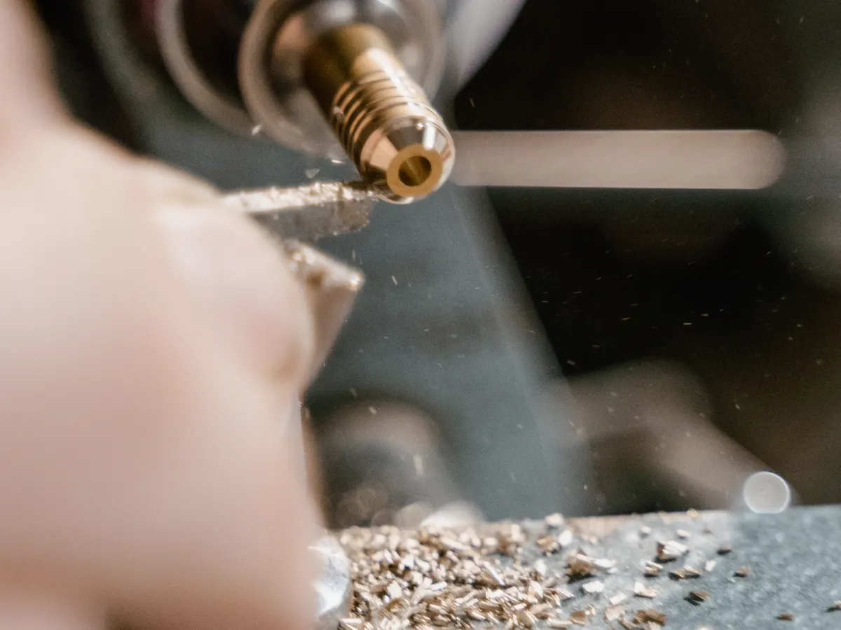 Turning a brass part on a lathe, chips flying